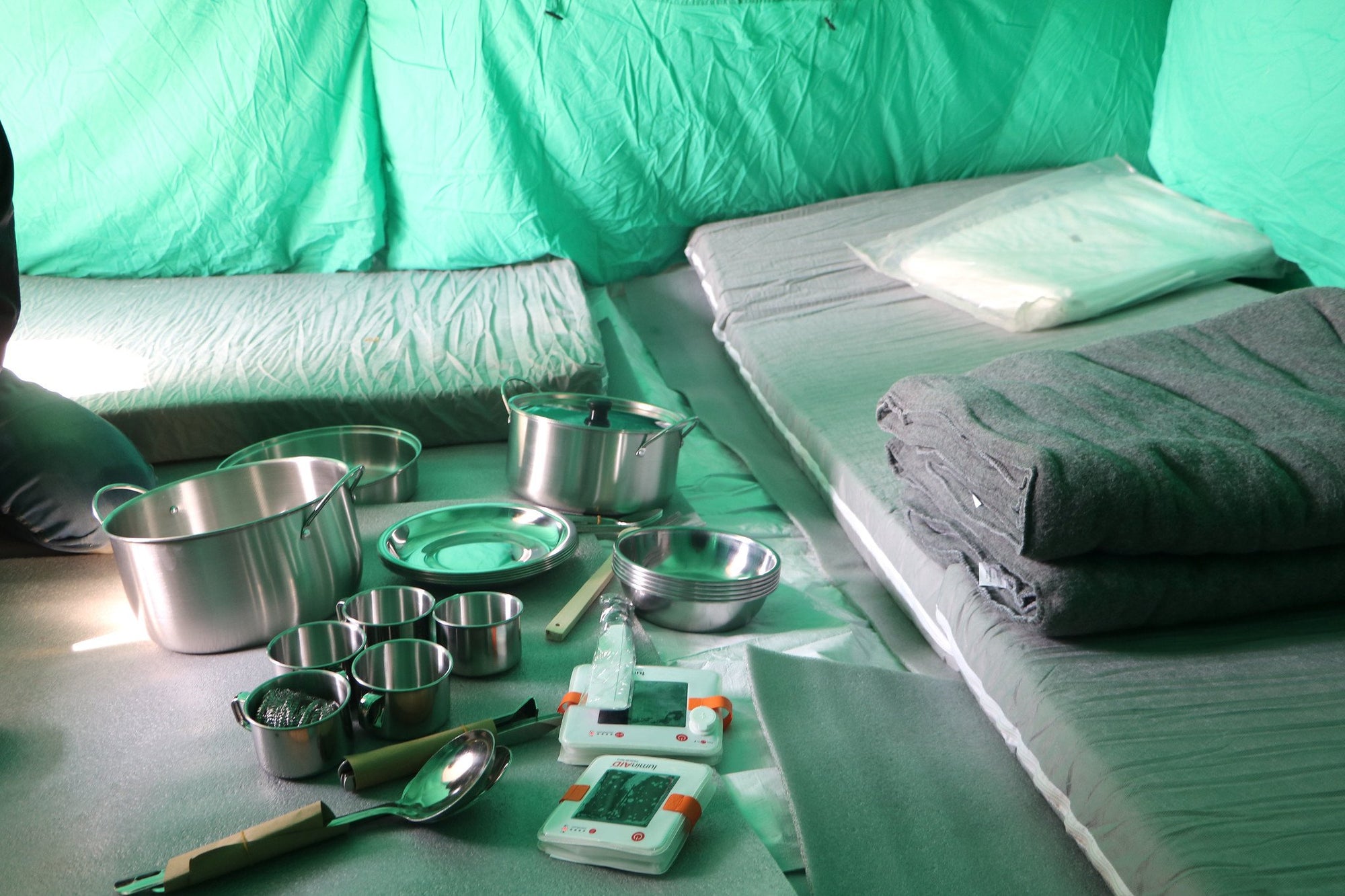 LuminAID lanterns in a tent with emergency supplies