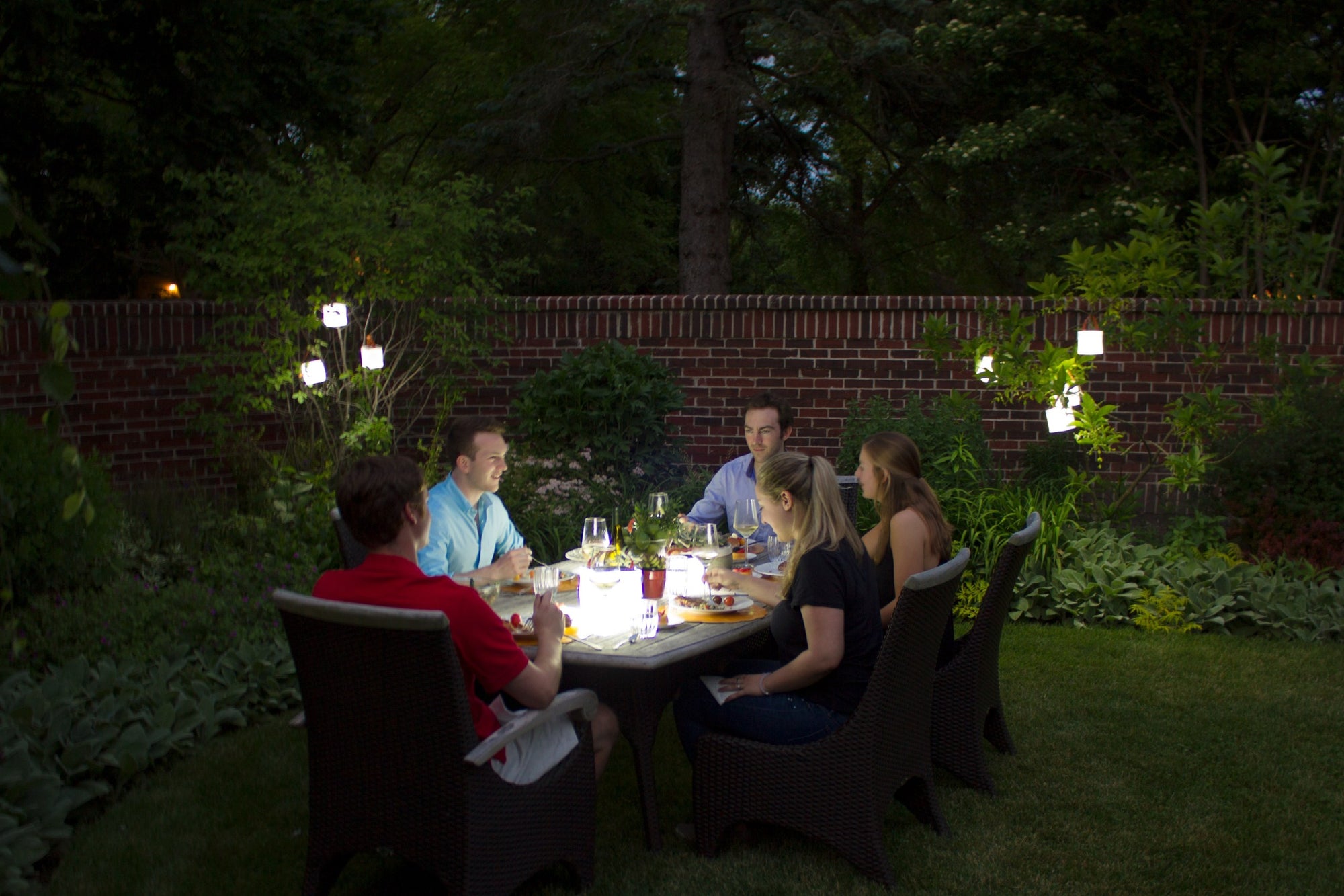 Friends enjoying a meal together in a backyard. Source: Hubbard Woods