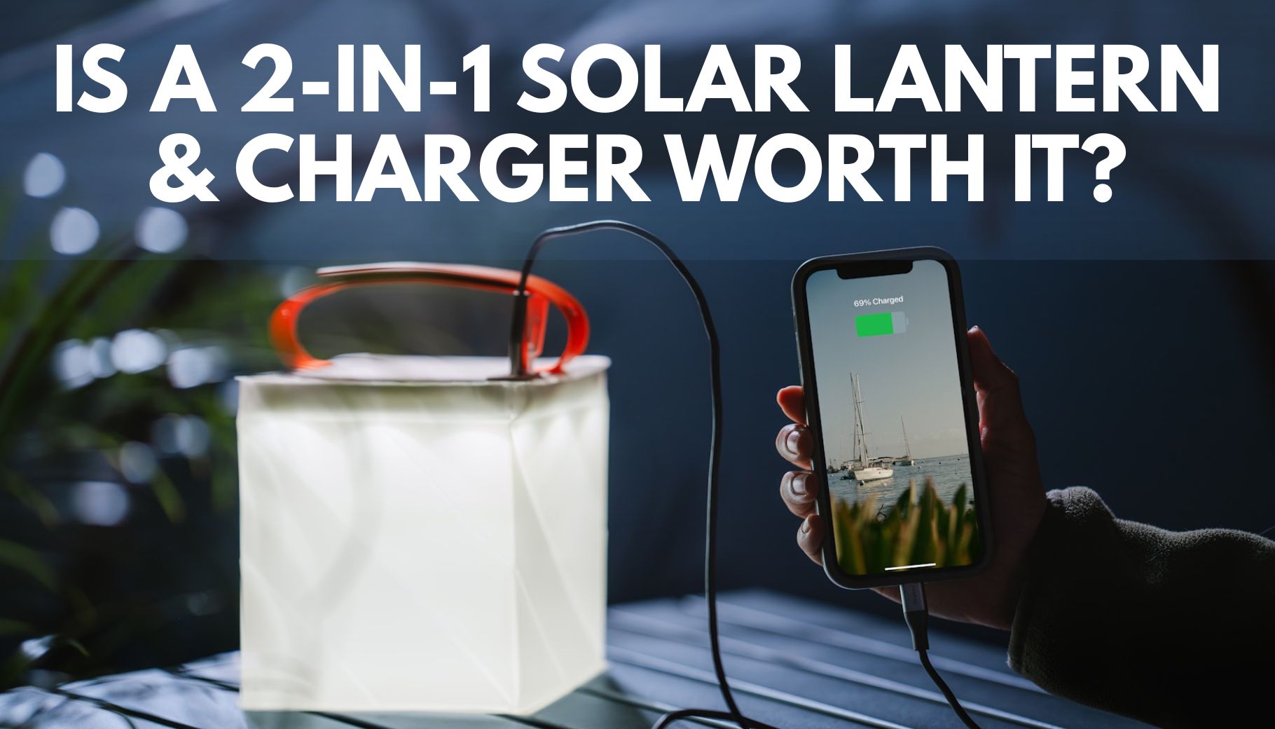an inflatable solar lantern sitting on a table with a phone charging cord plugged into it and charging a phone