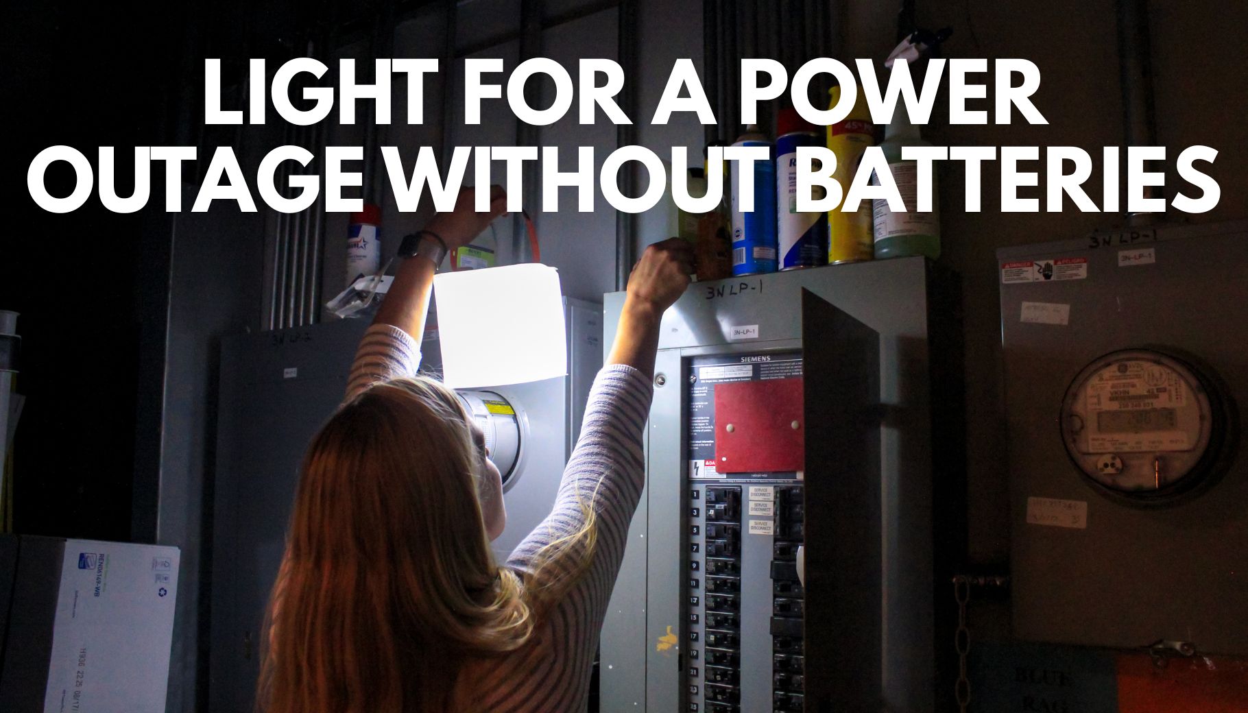 person holding lantern in front of fuse box