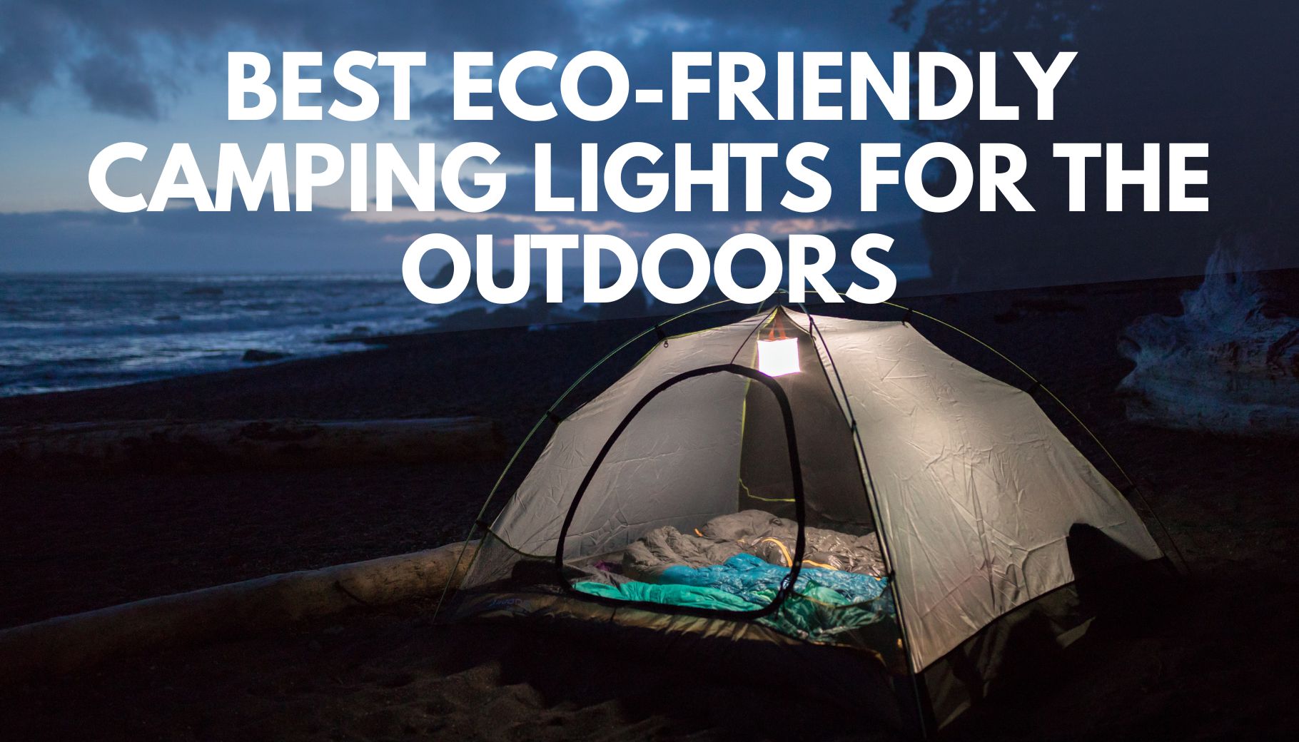 tent set up by the ocean at night with a lantern in the tent