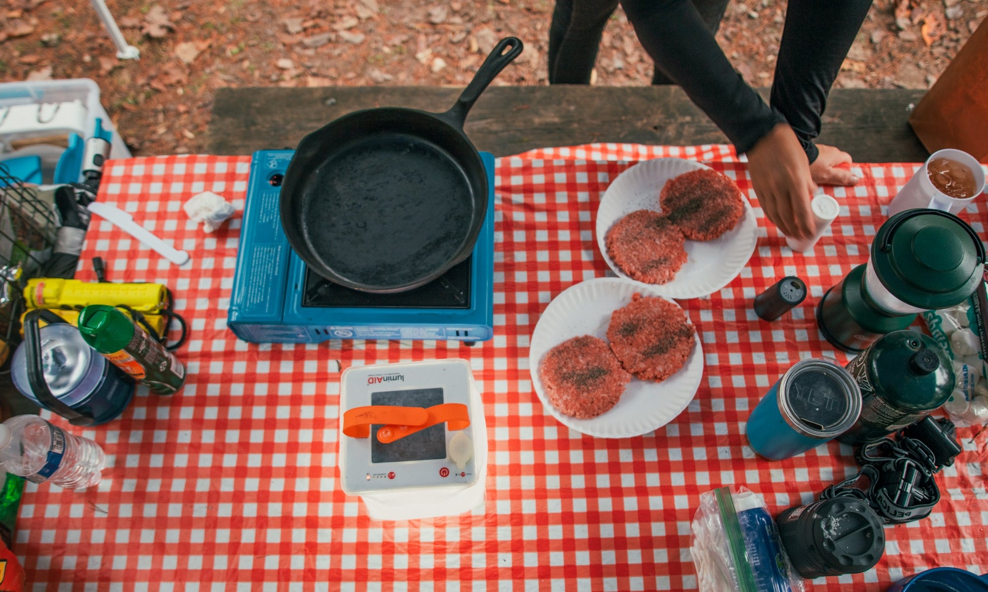 Camping stove and burgers atop a picnic table. Source: Zoe Szabo (IG: @zoeszabophotography)