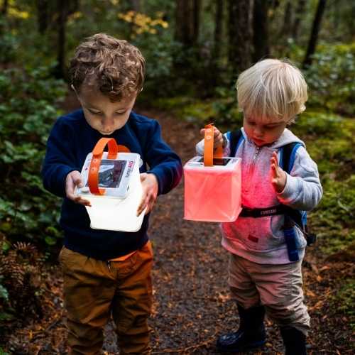 Two kids hiking in the woods love their solar lanterns.