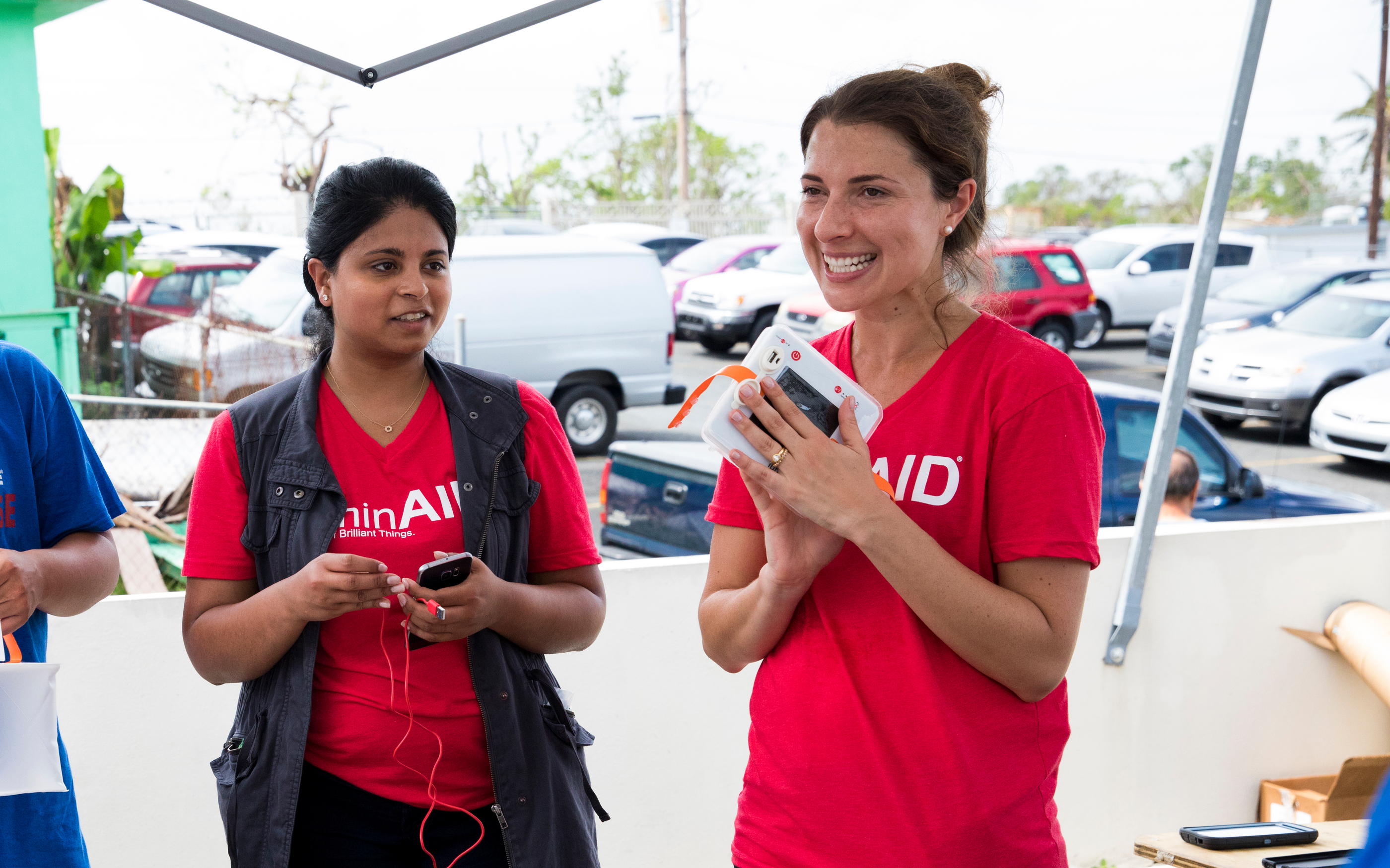 Andrea and Anna handing out LuminAID lights after a natural disaster.