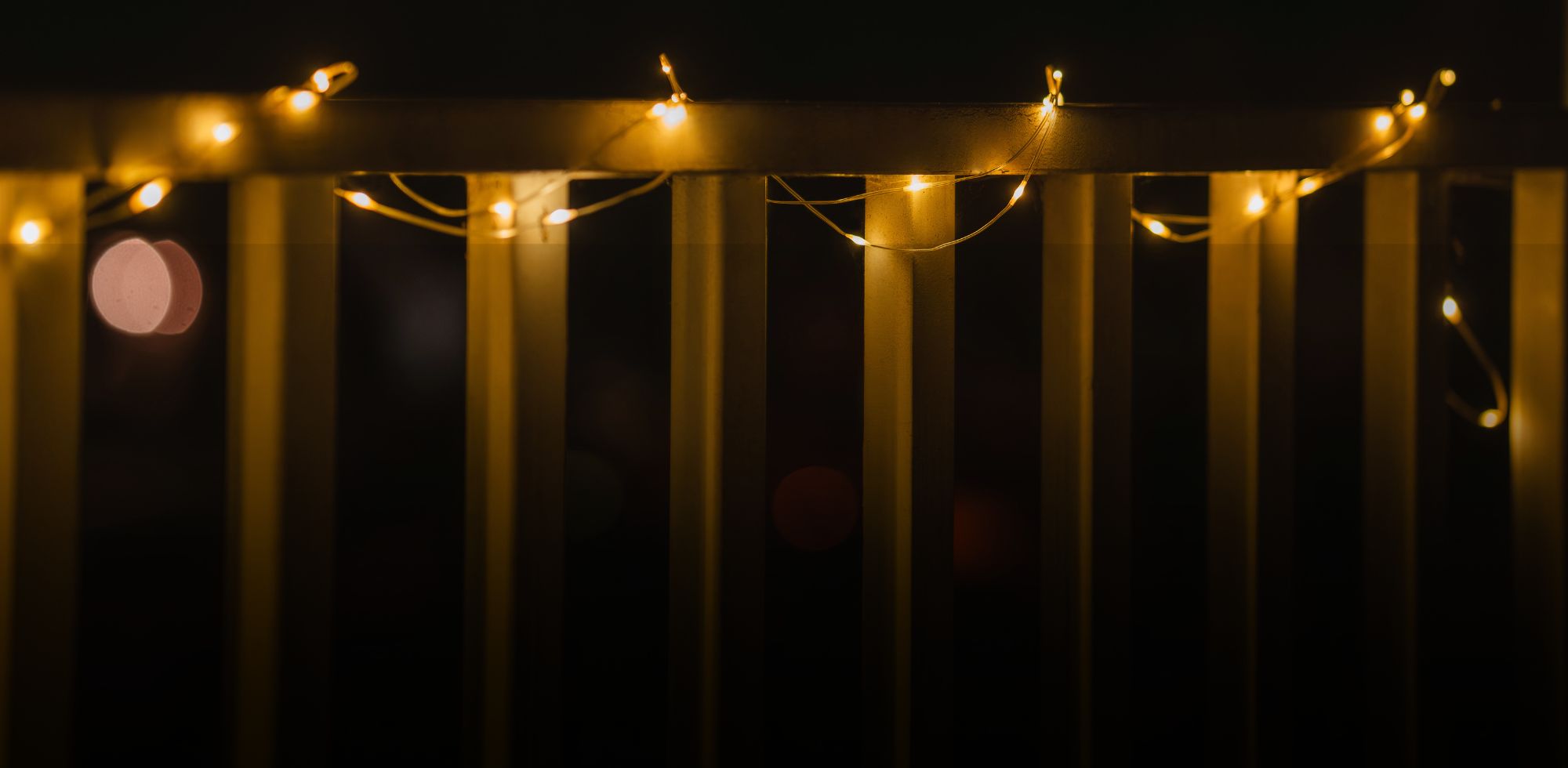 LuminAID Solar String Lights on railing of dark porch