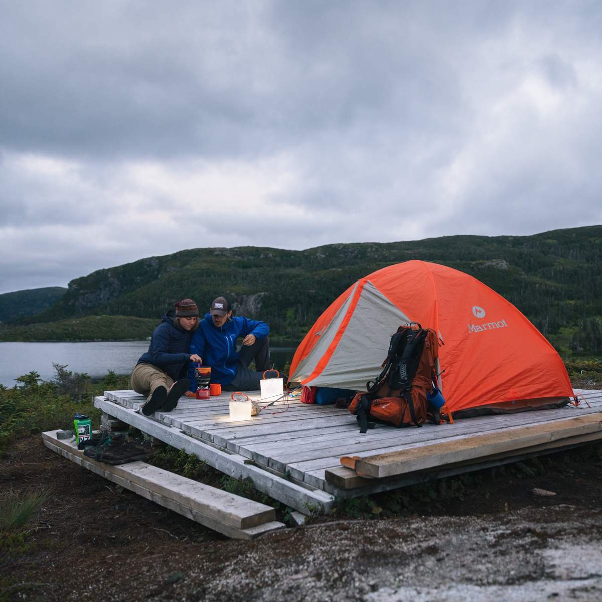 Man and woman camping on a cloudy day