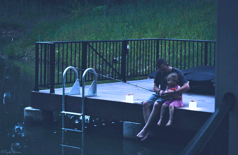 Father fishing with their daughter on a deck. Source: Kyle Green