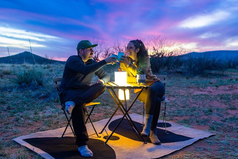 People at table with lantern in desert. Source: Melissa Reyerson-Slifer (IG: @meltakesahike)