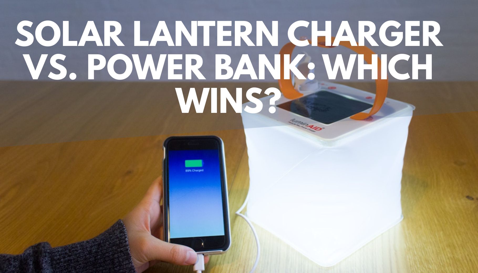 inflatable solar lantern sitting on a table charging a phone through a charging cord