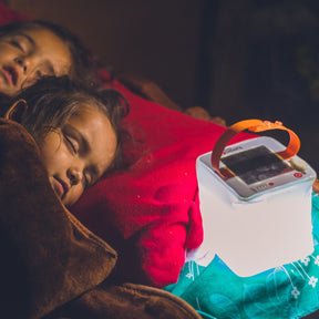 Two girls sleeping with a Nova USB lantern
