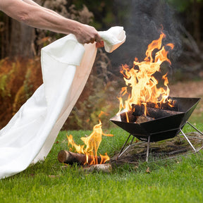 Emergency Fire Blanket using blanket to cover out of control fire in fire pit