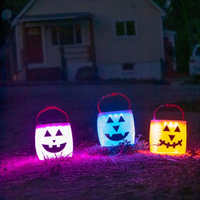 3 LuminAID jack-o-lanterns in front of a house