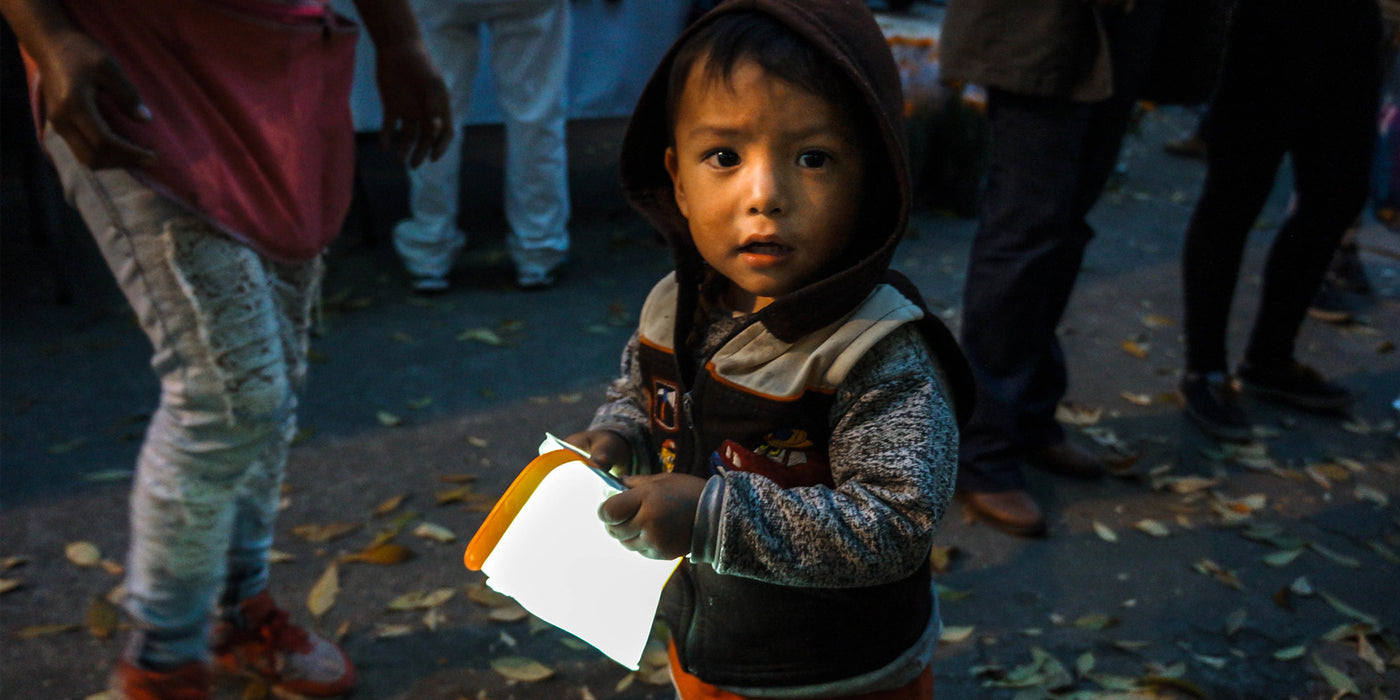 Child holding a solar lantern.
