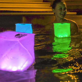 Woman in pool with spectra lights in different colors.