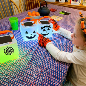 Child with two halloween sticker lanterns.