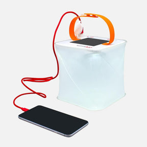 Packlite Max power lantern charging a phone.